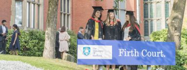 New graduates in their robes outside Firth Court