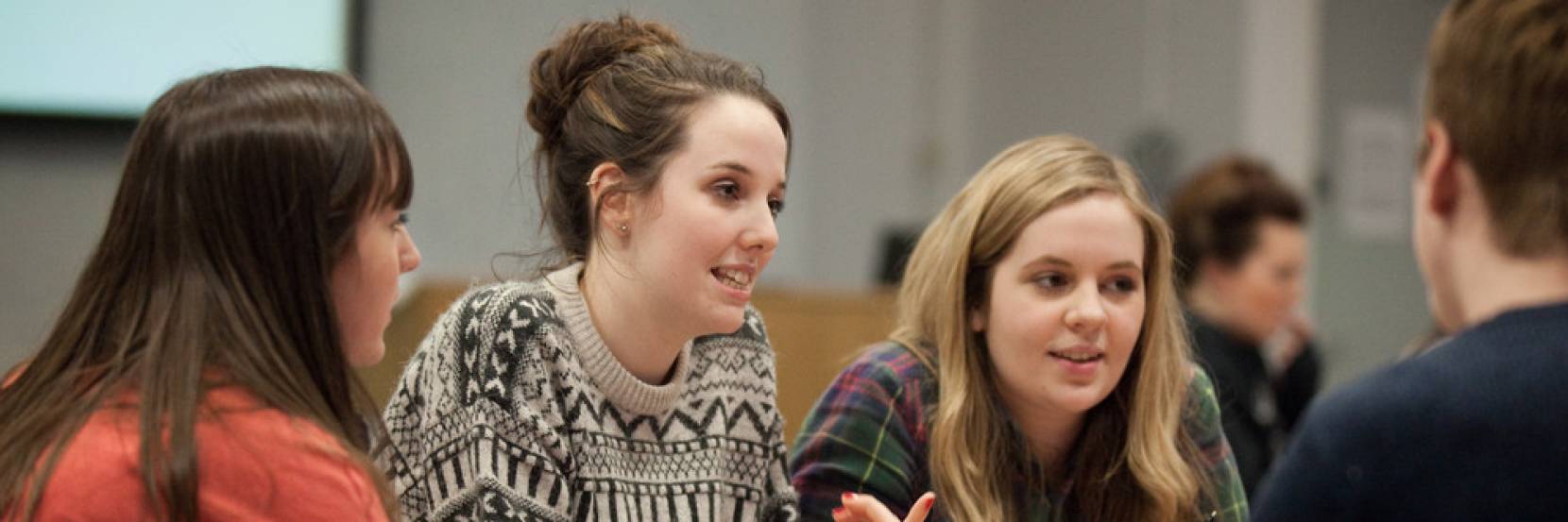 Students sitting at a table in discussion