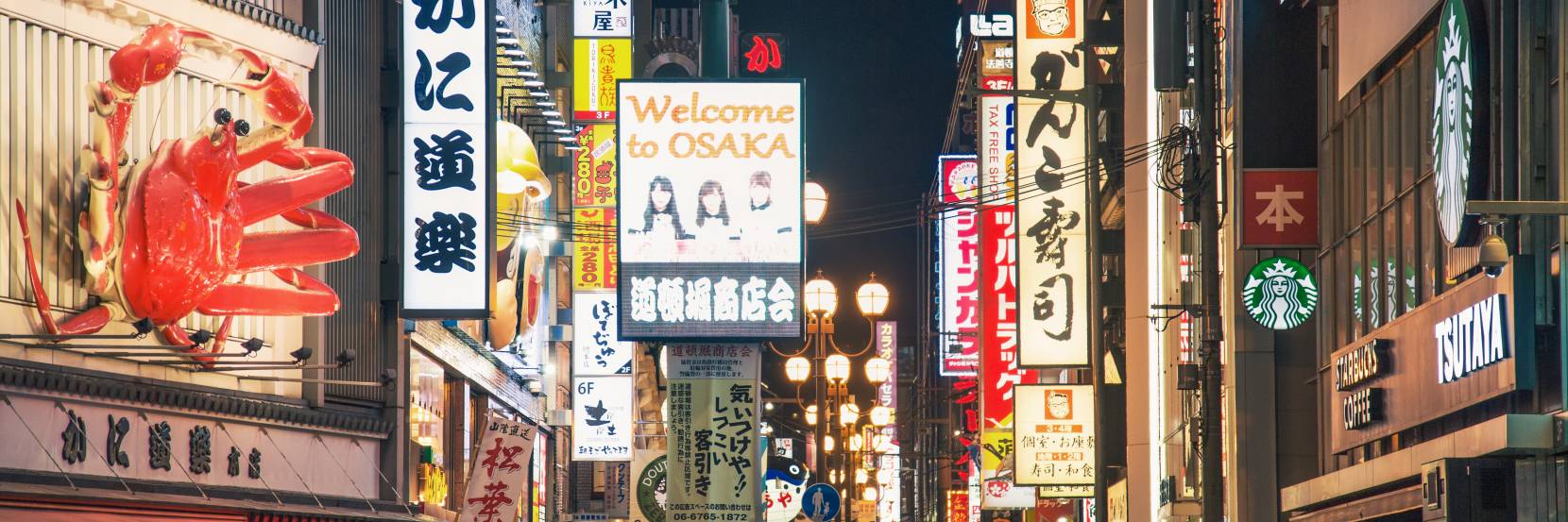 People walking down a busy street in Osaka, Japan.