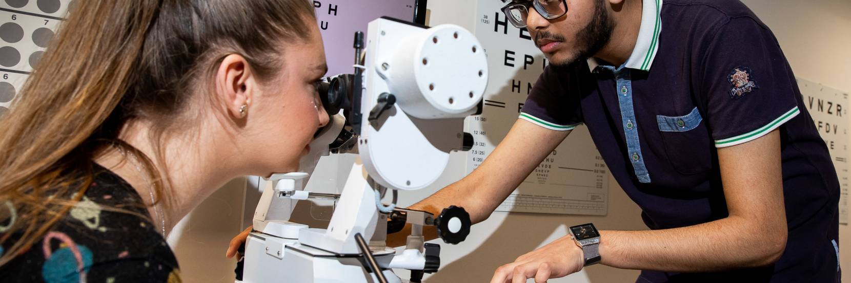 Orthoptics student giving an eye test to a patient