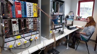 Particle Physics student working with equipment