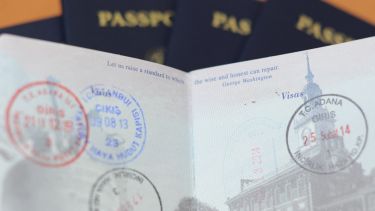 A passport with various visa stamps