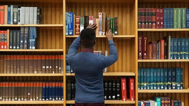 student in library