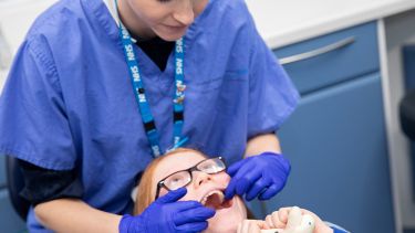 A dentist treating a young patient. 