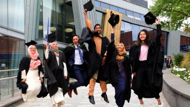 Happy graduands jumping in the air