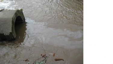 Polluted water entering a pipe