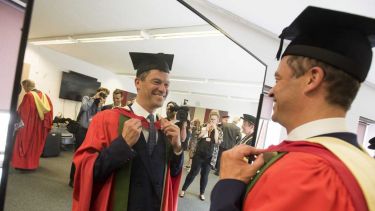 Hon grad Dominic West in robes