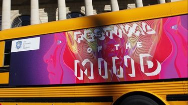 Banner on the side of the festival of the mind bus, parked outside city hall