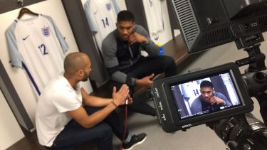 Journalism graduate Sam Moir interviews a footballer for a Chelsea FC video in the England dressing room