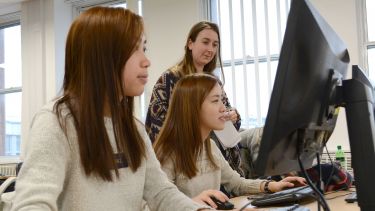 Psychology students learning at a computer