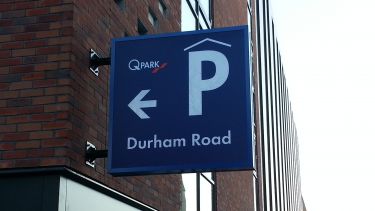 A sign indicating the direction of QPark on Durham Road