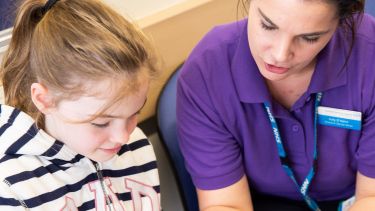 CALM Trial staff member with child