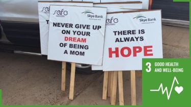signs at an infertility awareness event in The Gambia