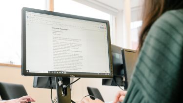 Student typing at a computer