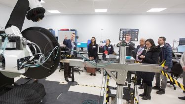 Photograph of Eddie Ball showing the lab to visitors during an open day at the mmWave facility