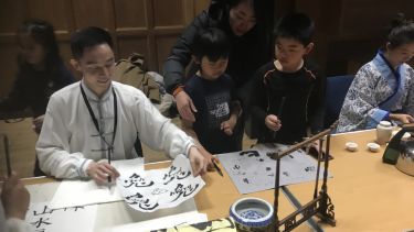 Attendees enjoy the Chinese Calligraphy Stall