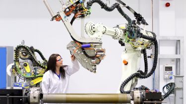 Woman using large machine in AMRC composites centre