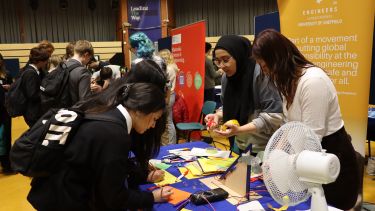 Photograph of students engineering wind turbines at the Engineers without Borders stand