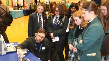 Students learn about mechanical engineering at the Department's stand at the exhibition