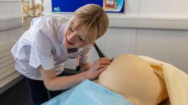 Isabel Gatenby practises listening to a baby's heartbeat