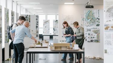 Visitors looking at landscape architecture models in the studio 