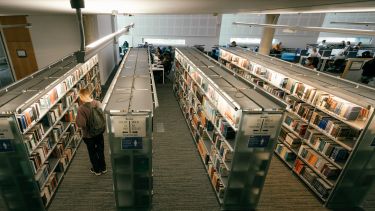 Student browsing books in the Information Commons