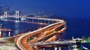 the Busan bridge lit up at night