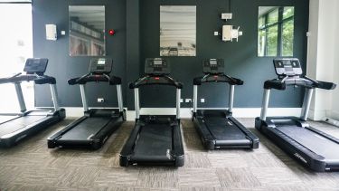 A row of running machines in front of a wall