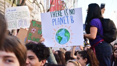 People at climate change protest: the sign reads 'there is no planet B'