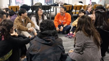 International students sitting in a circle and laughing