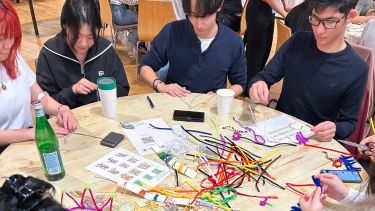 International students sitting around a table taking part in crafts
