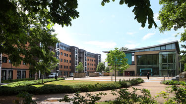 Accommodation building and The Edge with the piazza and trees 