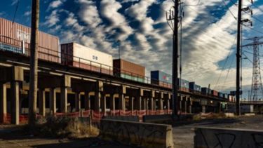 A freight train going over a bridge.