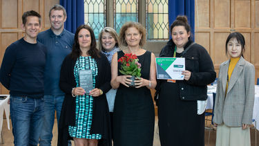 Photograph of staff and students from the School of Law holding their impact award