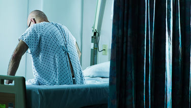 Senior man sitting on a hospital bed