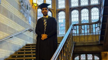 Sameer Zama Khan wearing graduating robes.
