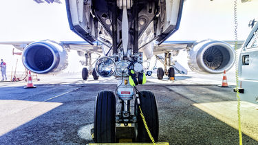 The view of a plane's wheels while stationary and awaiting departure