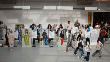 People looking at the Our People: Inspirational Women exhibition in the Wave foyer