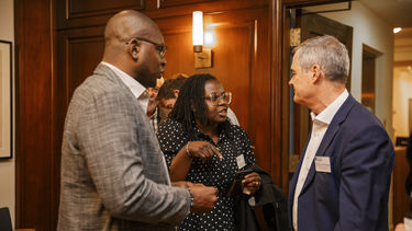 Three alumni enjoying the Lee Child USA event