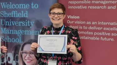 Rachael Green holding a Best paper award certificate.