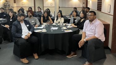 MBA students learning in a meeting room on an HMS ship.