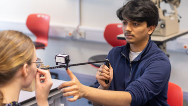 A student practising their clinical skills with an orthoptics tutor