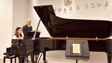 Student at a Steinway Piano in the Steinway showroom