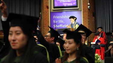 Image of students stood up in the hall looking back at audience