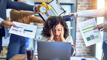 Group of business workers working together, with them stressing one colleague at the office.