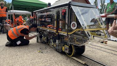 A student inspecting their locomotive