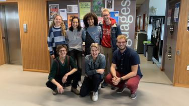 grpup of seven people in front of a door that reads Languages