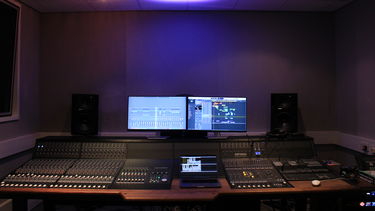 A LARGE MIXING CONSOLE IN A RECORDING STUDIO