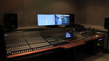 A large analogue mixing console in a recording studio