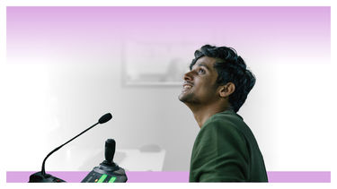 A male student at a console with a microphone